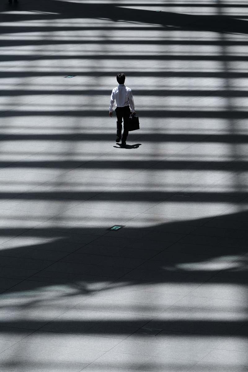 tokyo international forum man holding laptop bag walking on street chiyoda-ku